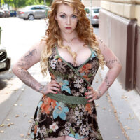 Tattooed redhead Harmony Reigns sets her big boobs free of a dress