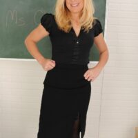 Blonde MILF does away with her business attire to pose nude