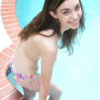 Hot teen Tali Dova frees her tiny tits from swimwear before getting in a pool