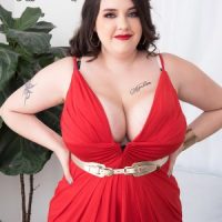 Tattooed BBW Nagini peels off a red dress while going nude