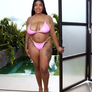 Thick Latina chick Thayana greases up her giant titties after shedding her bikini top
