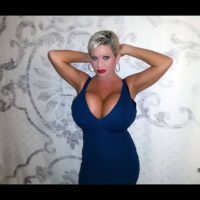 Blonde solo model Claudia Marie gargles on a nip after unsheathing her huge breasts