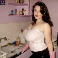 Brown-haired MILF Angela Milky modeling non nude in micro-skirt and in restroom and kitchen